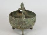 a small bronze bowl with a bird on it