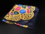 a close up of a pocket square with a colorful skull on it