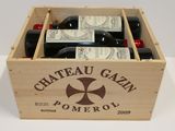 bottles of wine in a wooden crate on a white table
