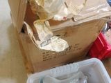 a box full of empty bottles and a plastic container filled with empty bottles