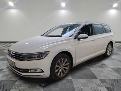 Une Volkswagen Passat blanche est garée sur un sol à damier.