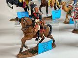 many figurines of men riding horses on display