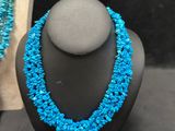 a necklace and earring set with turquoise beads on a mannequin