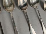 several spoons and spoon spoons are lined up on a table
