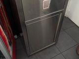 a soda machine in the corner of a kitchen