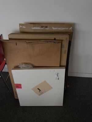 a stack of boxes sitting on top of a refrigerator