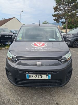 the van is parked in a parking lot with other cars
