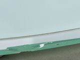 a close up of a white car with peeling paint on the side of it