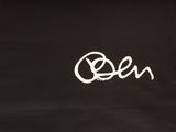 black and white photograph of a chalkboard with the word open written on it
