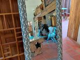 a mirror that is sitting on the floor in the room