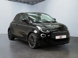 an image of a black smart car parked in a showroom