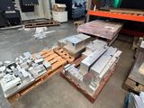 many pieces of metal on the floor in the warehouse