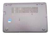 the bottom case of a laptop with a blue sticker on it