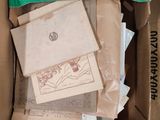 a cardboard box filled with assorted papers and other items