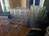 many empty wine glasses sitting on a table next to a bottle