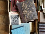 a box full of old books on the floor