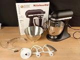 a kitchen aid mixer on a wooden table with a box on it