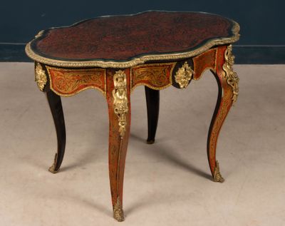 a small table with a red and gold decoration on it