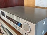 an image of a stereo system sitting on top of a wooden shelf