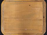 an old wooden cutting board on a black surface