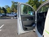 a white van with the door open in a parking lot