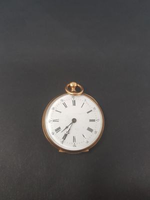 an antique pocket watch with roman numerals on a black background