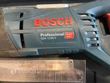 a close up of a bosch power tool on a table