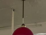 a red light hanging from the ceiling in a room