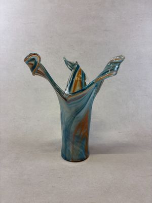 a glass vase with two toothbrushes sticking out of it