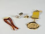 three different types of gold and silver jewelry on a white surface