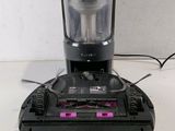 a black and pink blender sitting on a white table