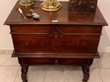 a wooden chest with a lamp on top of it