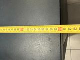 a measuring tape that is on the floor of a kitchen