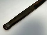 a baseball bat that is laying on a table