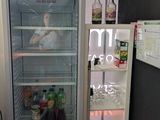 a refrigerator that is sitting in the corner of a room