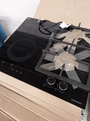 a black stove top sitting on top of a cardboard box