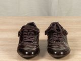 a pair of shoes that are on a wooden table