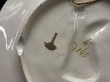 a white plate with a small bird on it