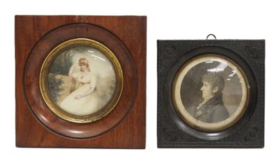 two framed pictures of a man and a woman on a wall