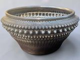 a silver bowl that is sitting on a table