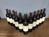 many bottles of wine that are lined up on a table