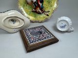 a plate, a bowl, and a plate with a picture of a man on it
