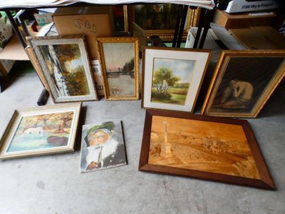 a lot of framed pictures on the floor in a room