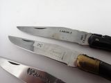 three knives that are sitting next to each other on a table