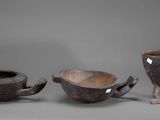three pieces of pottery sitting next to each other on a gray surface