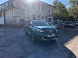 the car is parked in front of the building with the sun shining on it