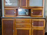 a cabinet that has many drawers and cupboard doors