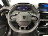 the interior of a car with a steering wheel and dashboard controls
