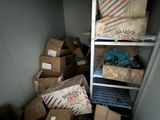 a closet full of boxes and a laptop on a shelf