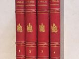 un lot de quatre livres rouges posés sur une table blanche